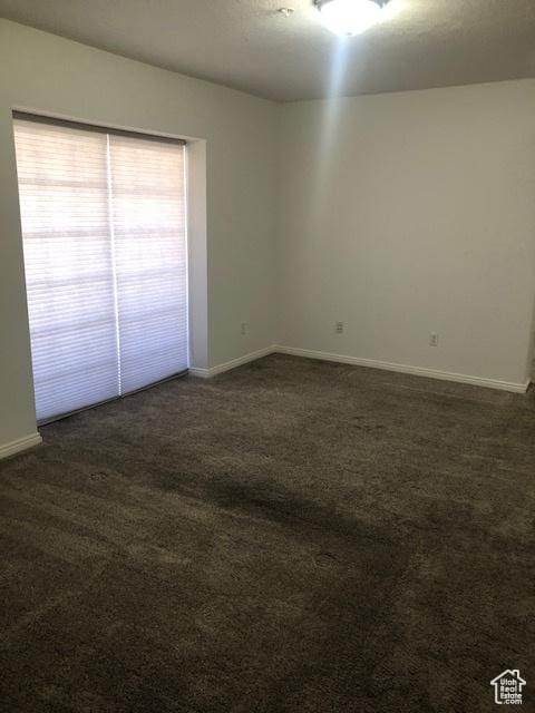 1529 W Westbury Way Unit C, Lehi, UT 84043 - empty room with dark carpet and baseboards