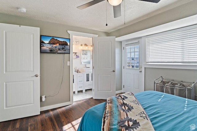bedroom featuring a textured ceiling, a sink, ceiling fan, baseboards, and dark wood-style floors