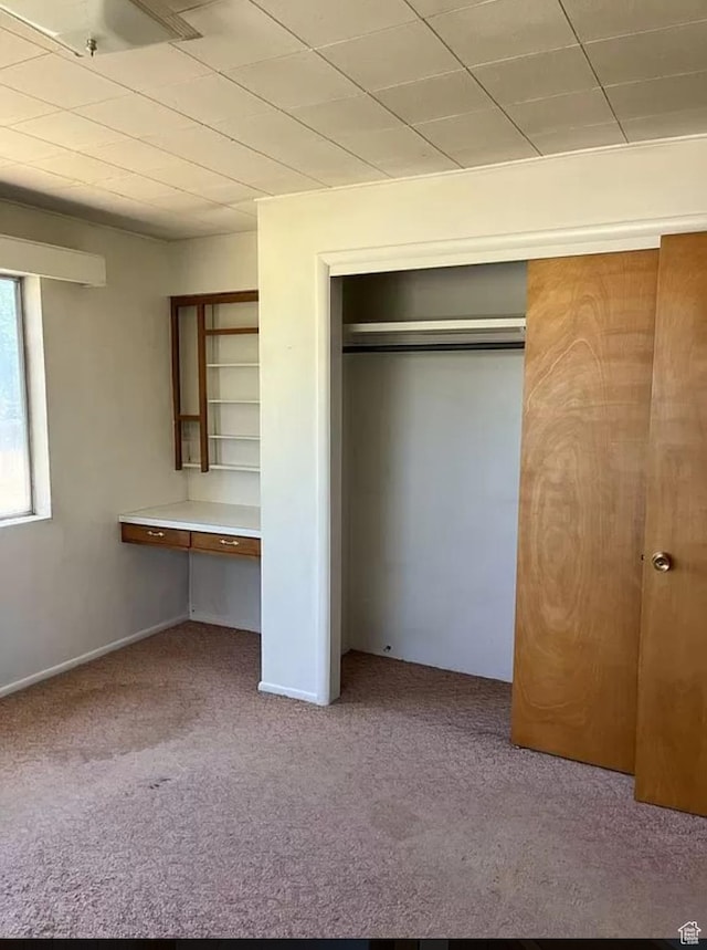 3440 S 4000 E, Vernal, UT 84078 - unfurnished bedroom featuring built in desk, carpet, and a closet