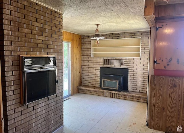3440 S 4000 E, Vernal, UT 84078 - unfurnished living room featuring wood walls and a brick fireplace