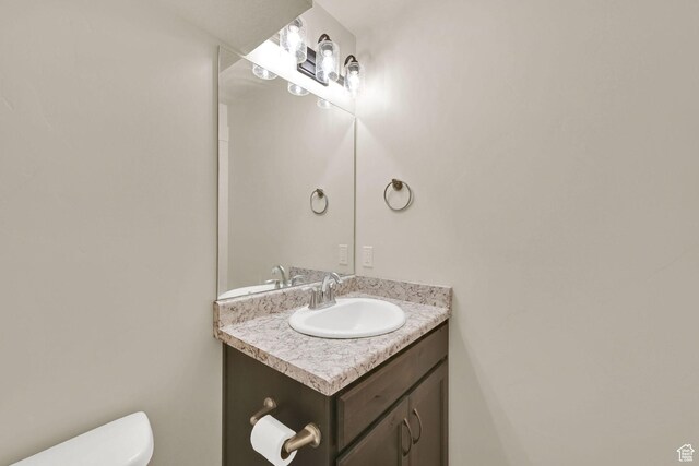 bathroom featuring toilet and vanity