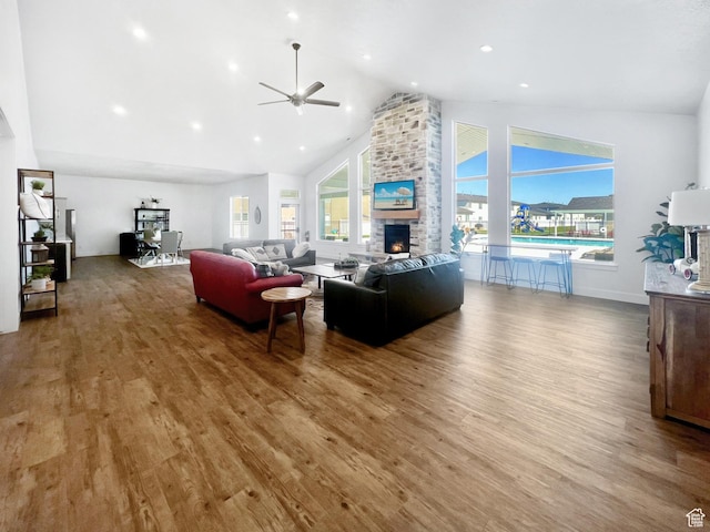 200 W 1200 S Unit 17, Tremonton, UT 84337 - living area featuring a ceiling fan, high vaulted ceiling, a fireplace, wood finished floors, and healthy amount of natural light