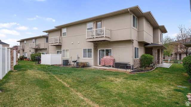 6661 W Merlot Way, West Jordan, UT 84081 - rear view of property featuring stucco siding, fence, central AC, and a lawn