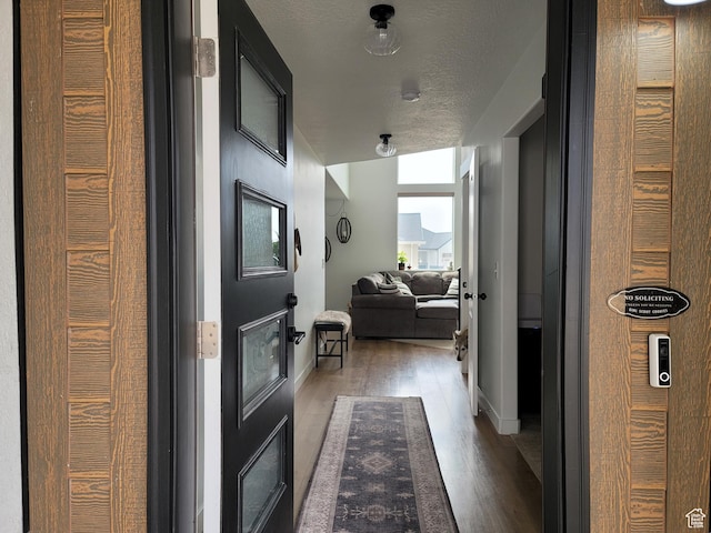 hallway with wood finished floors and baseboards