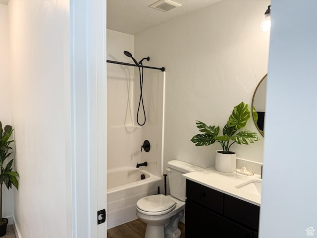 full bathroom featuring a textured ceiling, toilet, shower / bathing tub combination, visible vents, and vanity