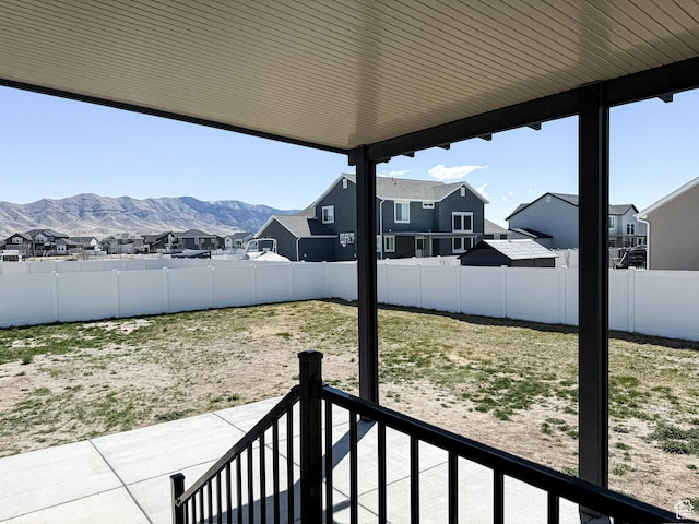 view of yard featuring a fenced backyard, a patio area, and a residential view