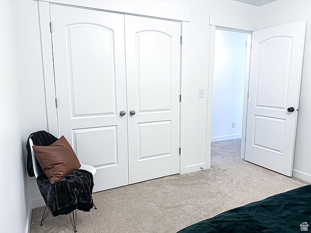 unfurnished bedroom with baseboards, a closet, and carpet