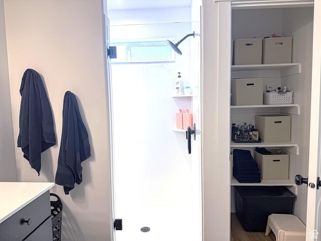 full bathroom with a shower stall and vanity