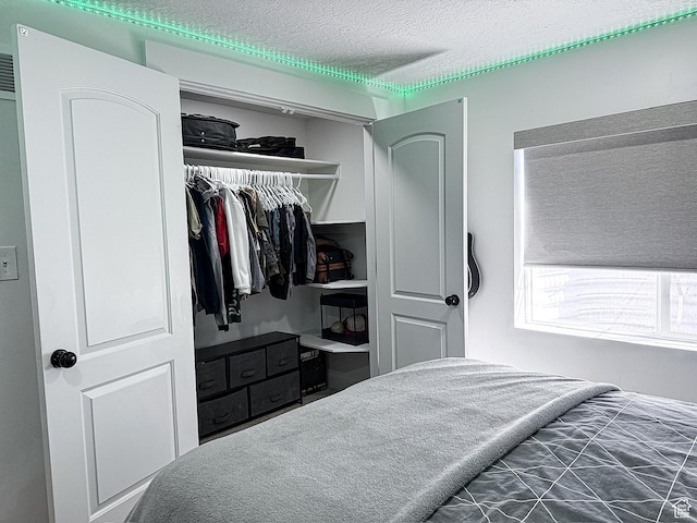 bedroom featuring a closet and a textured ceiling