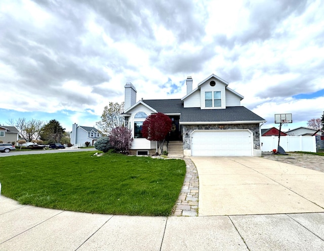 977 S Via La Costa Way, Kaysville, UT 84037 - traditional-style home featuring a chimney, fence, a front lawn, an attached garage, and driveway