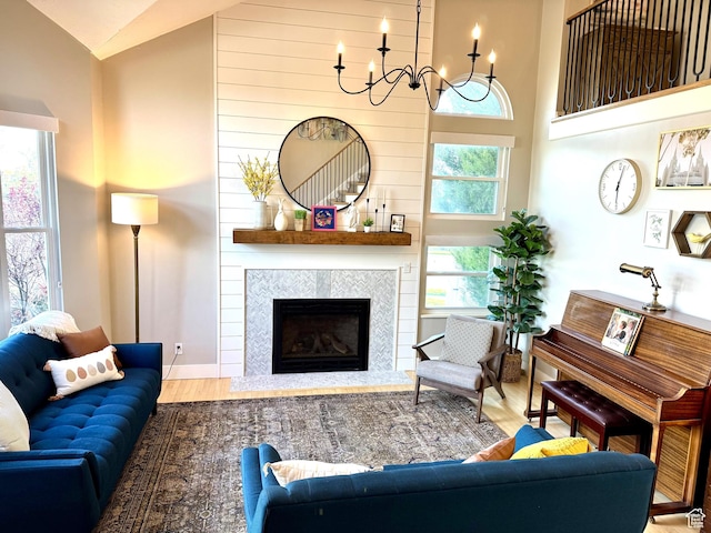 977 S Via La Costa Way, Kaysville, UT 84037 - living area featuring a tiled fireplace, baseboards, a chandelier, wood finished floors, and high vaulted ceiling