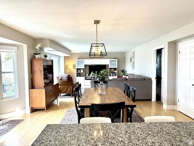 977 S Via La Costa Way, Kaysville, UT 84037 - dining space featuring baseboards, a textured ceiling, and light wood-type flooring