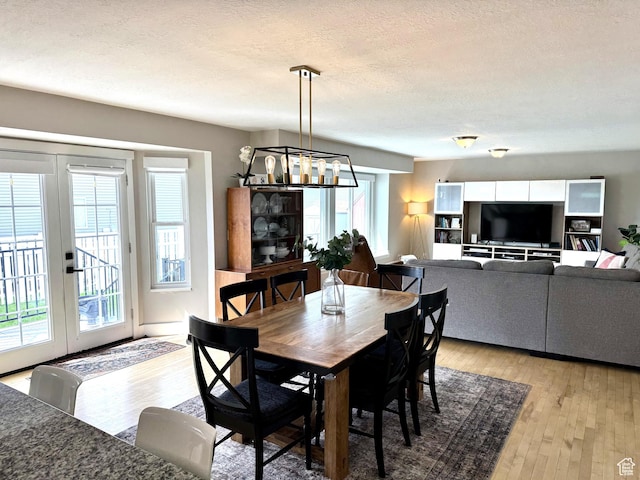 977 S Via La Costa Way, Kaysville, UT 84037 - dining area featuring french doors, a chandelier, a textured ceiling, and light wood-style floors