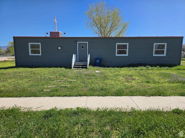 view of front of property with a front lawn and a chimney