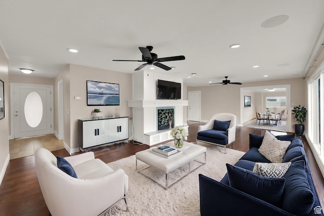 1936 E La Cresta Dr, Cottonwood Heights, UT 84121 - living area with baseboards, recessed lighting, a fireplace with raised hearth, a ceiling fan, and wood finished floors