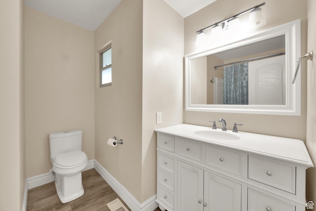 1936 E La Cresta Dr, Cottonwood Heights, UT 84121 - full bath with wood finished floors, vanity, baseboards, toilet, and visible vents