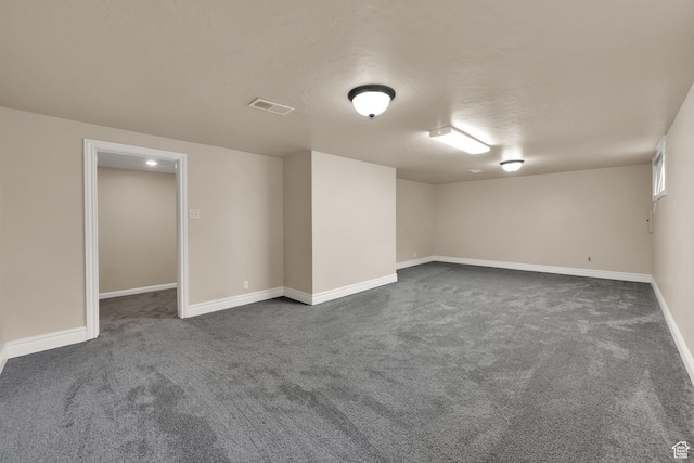 1936 E La Cresta Dr, Cottonwood Heights, UT 84121 - below grade area featuring dark carpet, visible vents, and baseboards