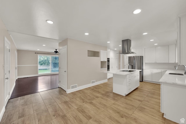 1936 E La Cresta Dr, Cottonwood Heights, UT 84121 - kitchen with island exhaust hood, a sink, visible vents, white cabinetry, and an island with sink