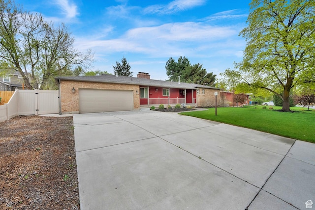1936 E La Cresta Dr, Cottonwood Heights, UT 84121 - single story home with a gate, a porch, concrete driveway, an attached garage, and a front yard
