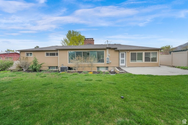 1936 E La Cresta Dr, Cottonwood Heights, UT 84121 - rear view of property with fence, a patio area, a chimney, and a yard