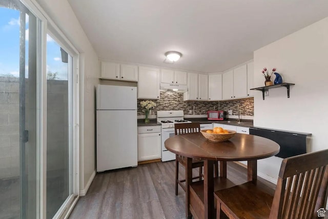 1465 W Arthur Dr, Provo, UT 84601 - kitchen with under cabinet range hood, dark countertops, white appliances, dark wood-type flooring, and tasteful backsplash