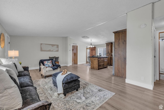 345 E 100 S, Coalville, UT 84017 - living area with a textured ceiling, a chandelier, and light wood-style floors
