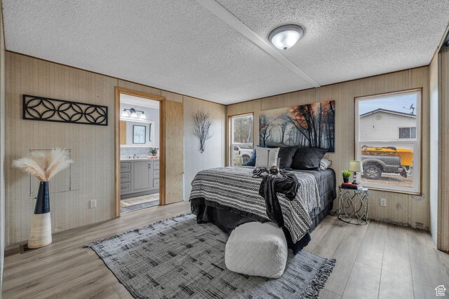 345 E 100 S, Coalville, UT 84017 - bedroom featuring light wood-type flooring, wooden walls, and ensuite bathroom