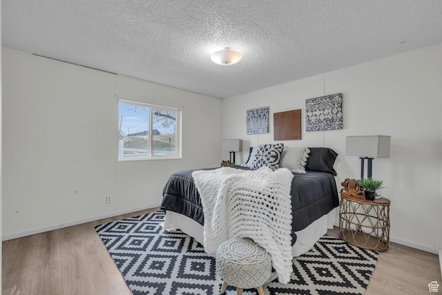 345 E 100 S, Coalville, UT 84017 - bedroom with a textured ceiling, wood finished floors, and baseboards