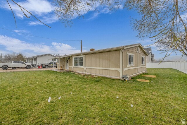 345 E 100 S, Coalville, UT 84017 - view of front facade with a chimney, fence, and a front yard