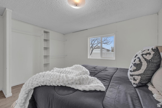345 E 100 S, Coalville, UT 84017 - bedroom with light wood-type flooring and a textured ceiling