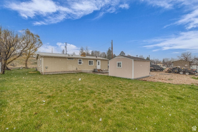 345 E 100 S, Coalville, UT 84017 - rear view of property featuring an outbuilding, a lawn, and a storage unit