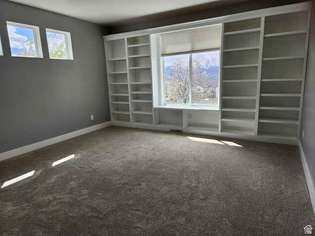 spare room with carpet flooring and baseboards