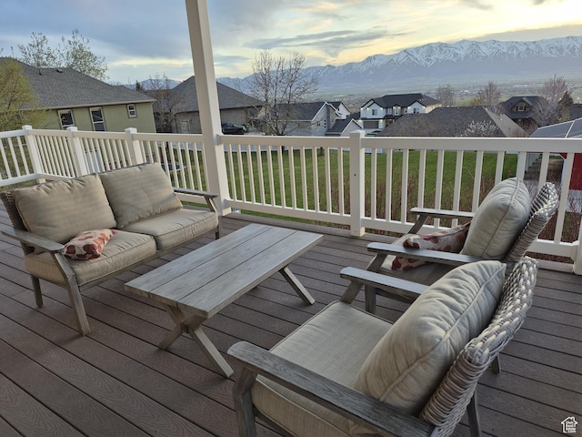 deck at dusk with outdoor lounge area, a mountain view, and a residential view