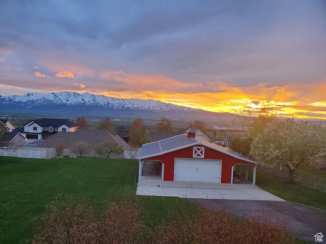 view of front of house featuring an outbuilding, concrete driveway, a mountain view, and a garage