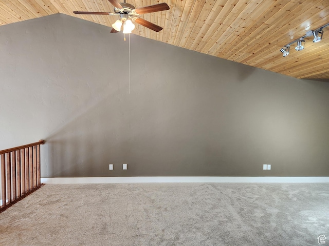 carpeted spare room with a ceiling fan, vaulted ceiling, baseboards, rail lighting, and wood ceiling