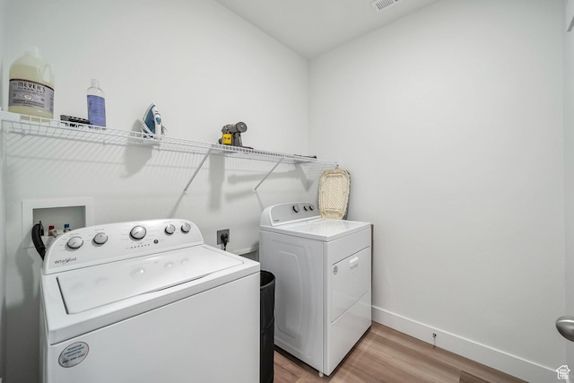 13537 S Commodus Dr W Unit 304, Riverton, UT 84096 - laundry room featuring light wood-type flooring, laundry area, washing machine and dryer, baseboards, and visible vents