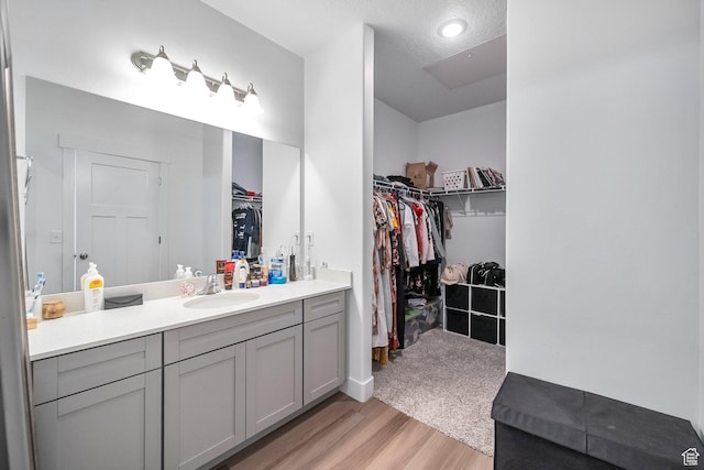 13537 S Commodus Dr W Unit 304, Riverton, UT 84096 - bathroom featuring wood finished floors, a spacious closet, and vanity