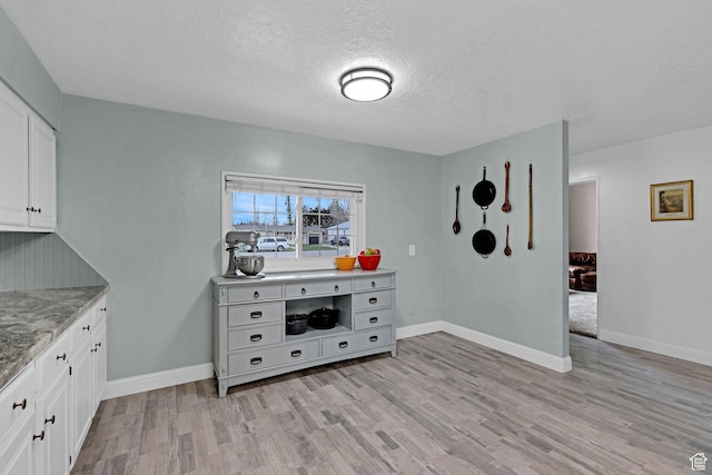 275 E 1st S, Preston, ID 83263 - interior space featuring light wood-style flooring, baseboards, and a textured ceiling
