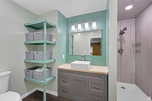 275 E 1st S, Preston, ID 83263 - full bathroom featuring recessed lighting, wood finished floors, toilet, vanity, and tiled shower