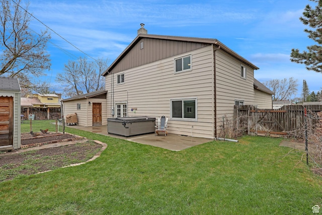 275 E 1st S, Preston, ID 83263 - back of property featuring a fenced backyard, a gate, a chimney, a patio area, and a yard