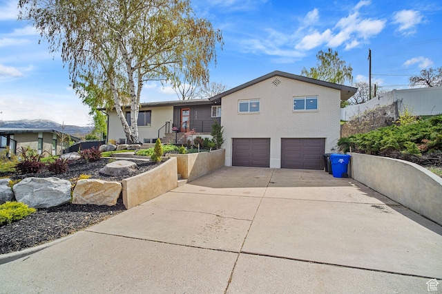 view of front facade featuring concrete driveway and a garage