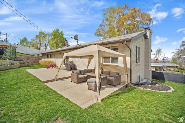 rear view of house featuring a chimney, fence, a patio area, an outdoor living space, and brick siding