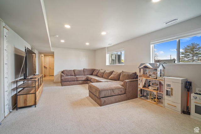 living room featuring light colored carpet, visible vents, and recessed lighting