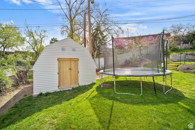 view of shed featuring a trampoline and fence