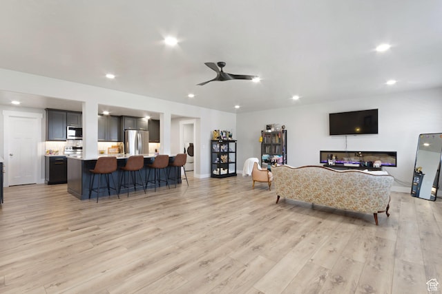 6982 W Majestic View Ln S, Herriman, UT 84096 - living area with baseboards, recessed lighting, a ceiling fan, and light wood-type flooring