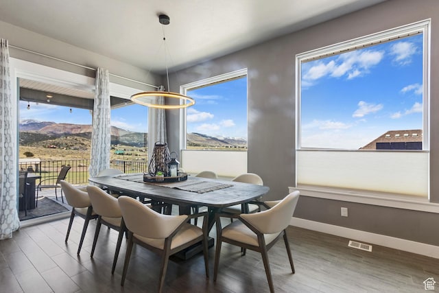 6982 W Majestic View Ln S, Herriman, UT 84096 - dining space featuring baseboards, wood finished floors, visible vents, and a mountain view