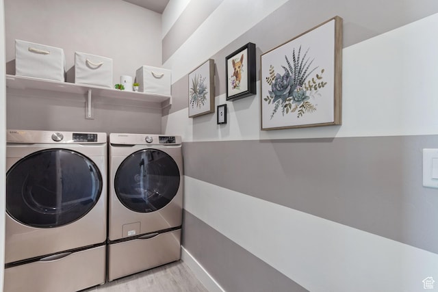 6982 W Majestic View Ln S, Herriman, UT 84096 - laundry room featuring washing machine and clothes dryer, wood finished floors, laundry area, and baseboards