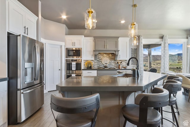 6982 W Majestic View Ln S, Herriman, UT 84096 - kitchen with stainless steel appliances, backsplash, dark countertops, wood finished floors, and a sink