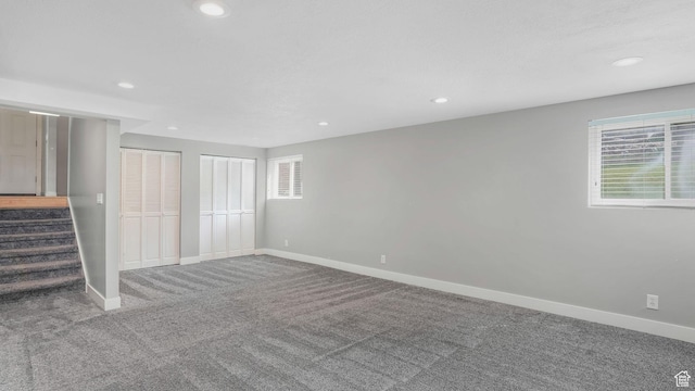 unfurnished bedroom featuring two closets, carpet floors, recessed lighting, and baseboards