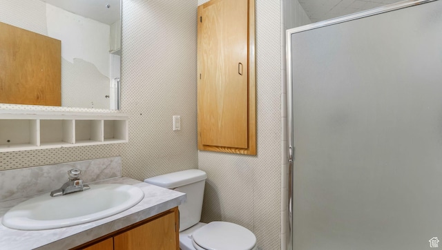 full bath with a shower stall, toilet, and vanity